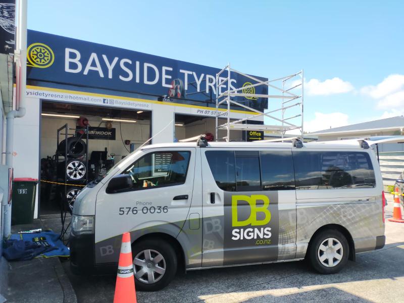 Van With DB Signs Decals In Front of Bayside Tyres